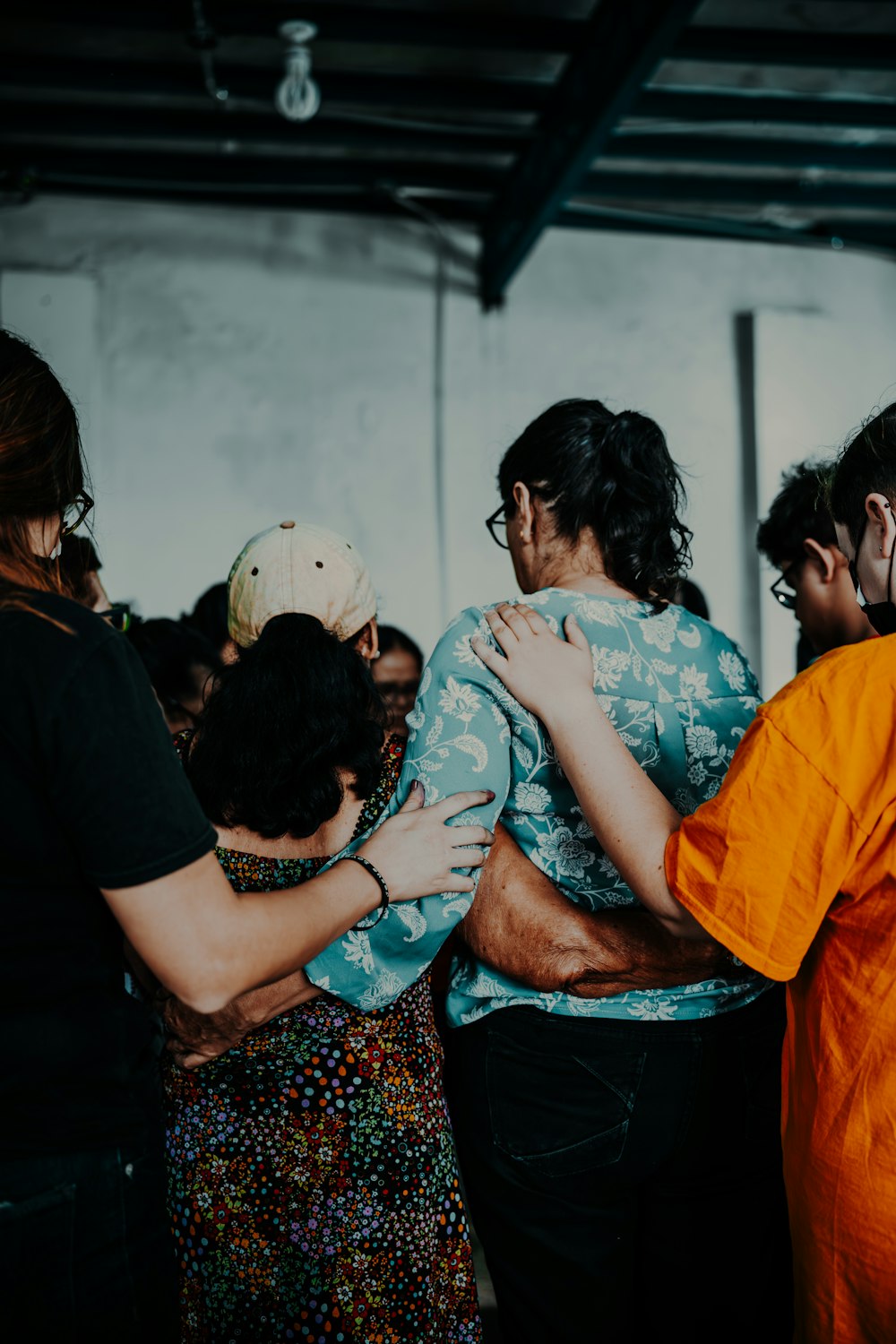 a group of people standing around each other