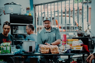 Warm photo of the Kurdish family behind Kurd Halal standing proudly in their meat supply warehouse.