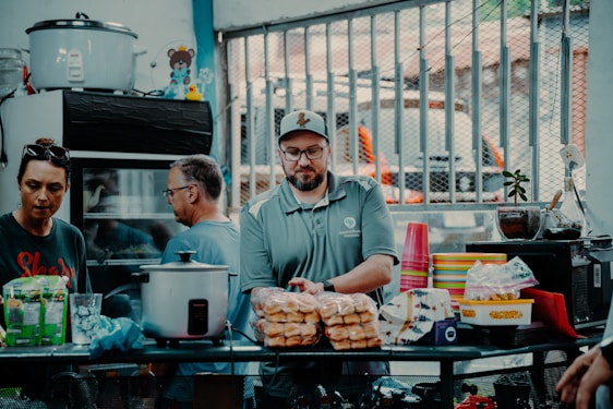 A warm photo of the Kurdish family behind Kurd Halal standing proudly in front of their meat supply warehouse.