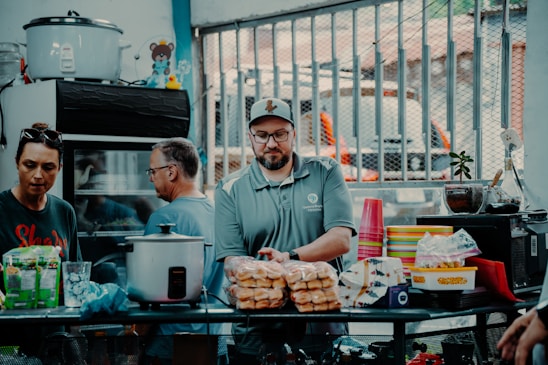 Warm photo of the Kurdish family behind Kurd Halal standing proudly in their meat supply warehouse.