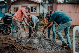 a group of men are digging in the dirt