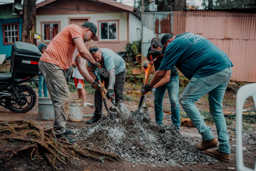 a group of men are digging in the dirt
