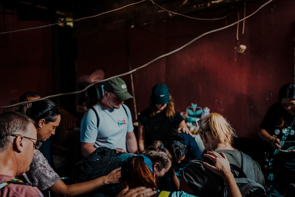 a group of people standing around each other