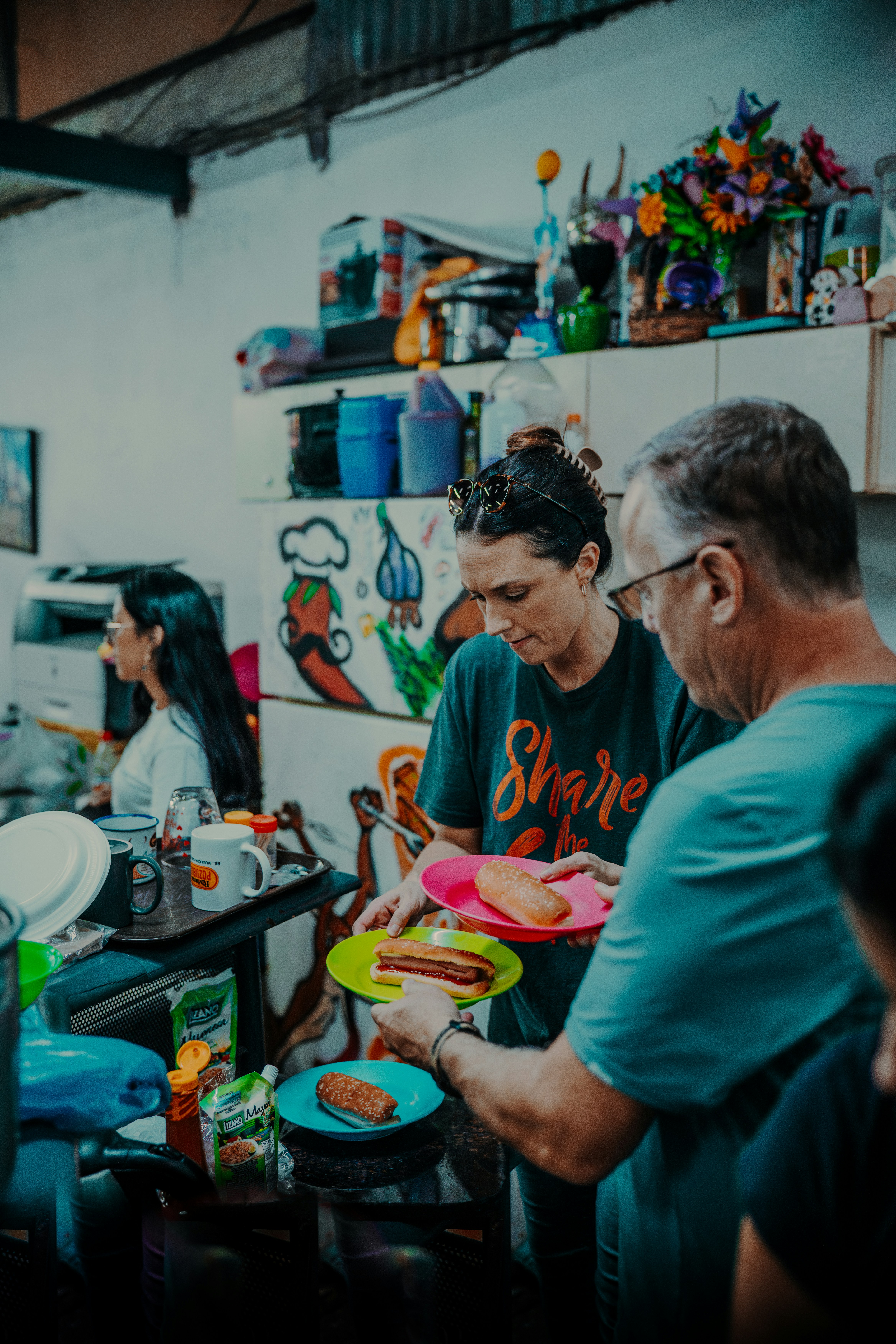 a group of people standing around a kitchen