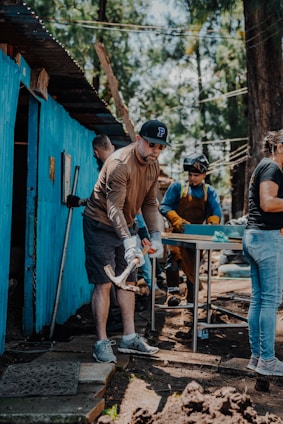 Volunteers working side by side to repair a damaged home after a natural disaster.