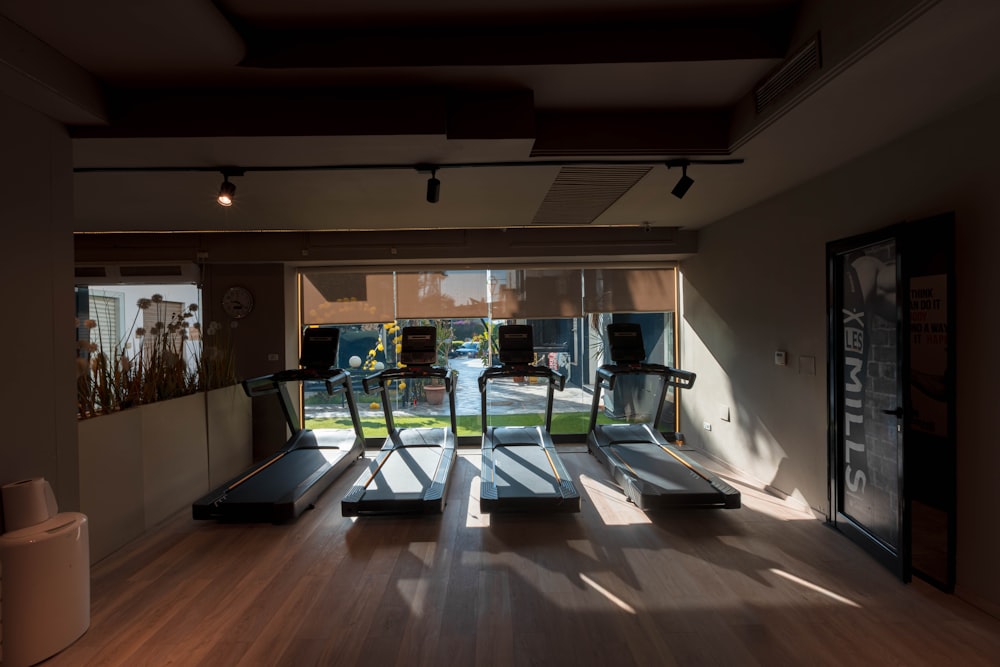 a room with a treadmill and a large window