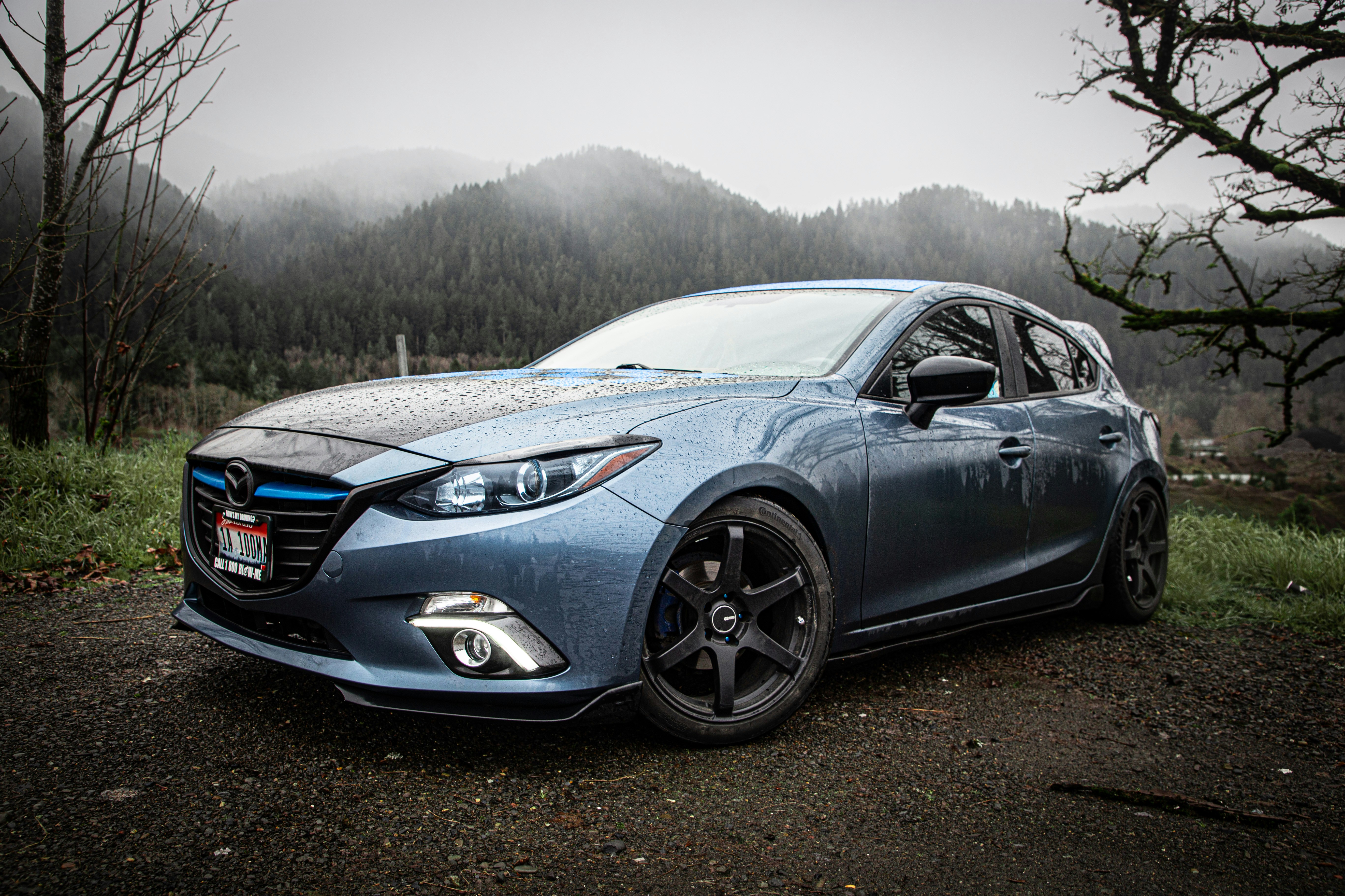 a blue car parked on the side of a road