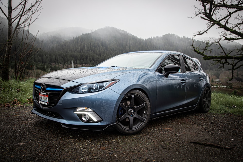 a blue car parked on the side of a road