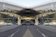 A panoramic view of a highway project in progress with multiple crews working.