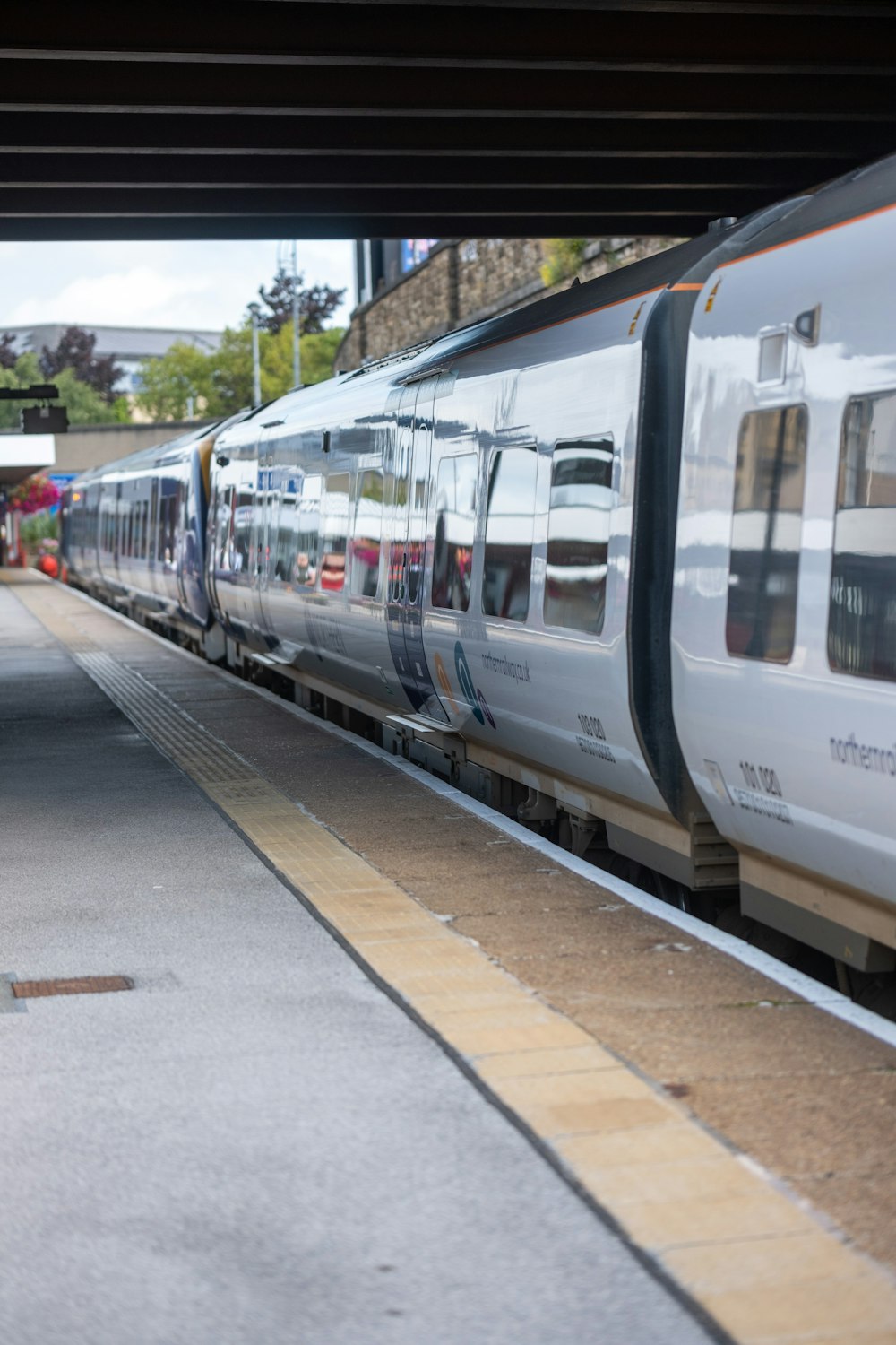 a white train pulling into a train station