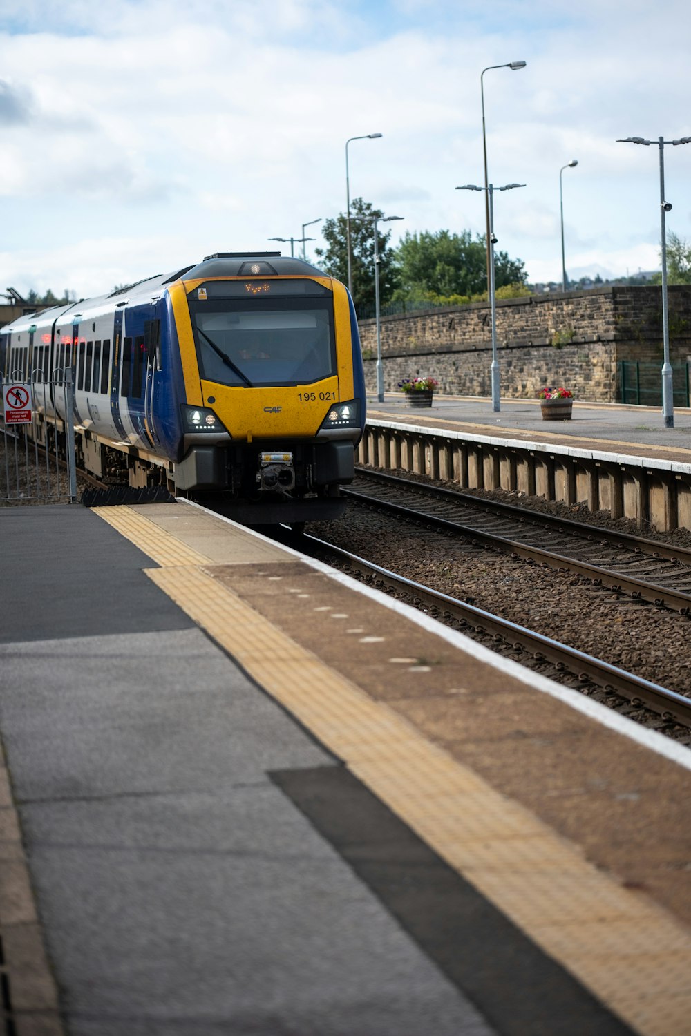 a yellow and blue train traveling down train tracks