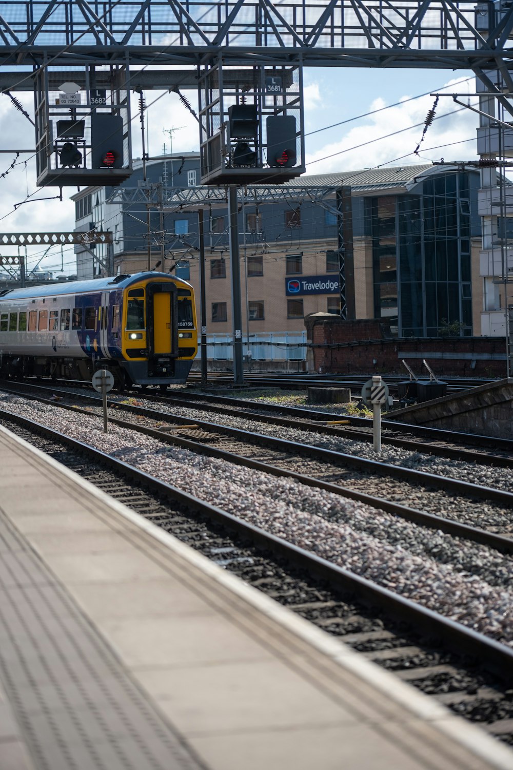 a yellow and blue train traveling down train tracks