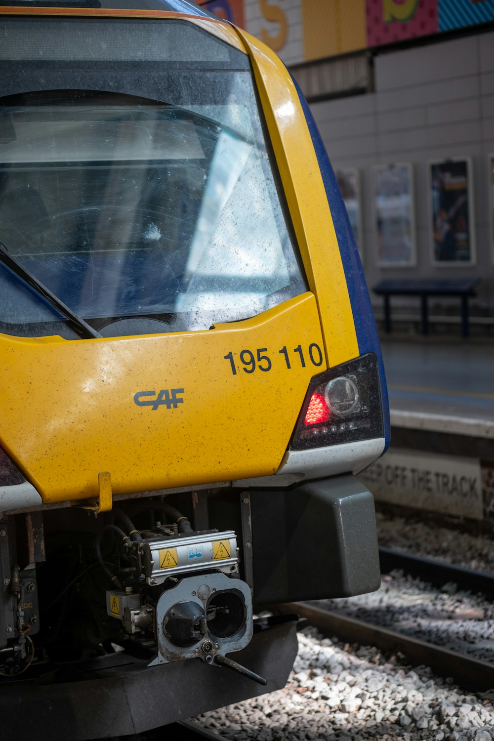 a yellow and blue train traveling down train tracks