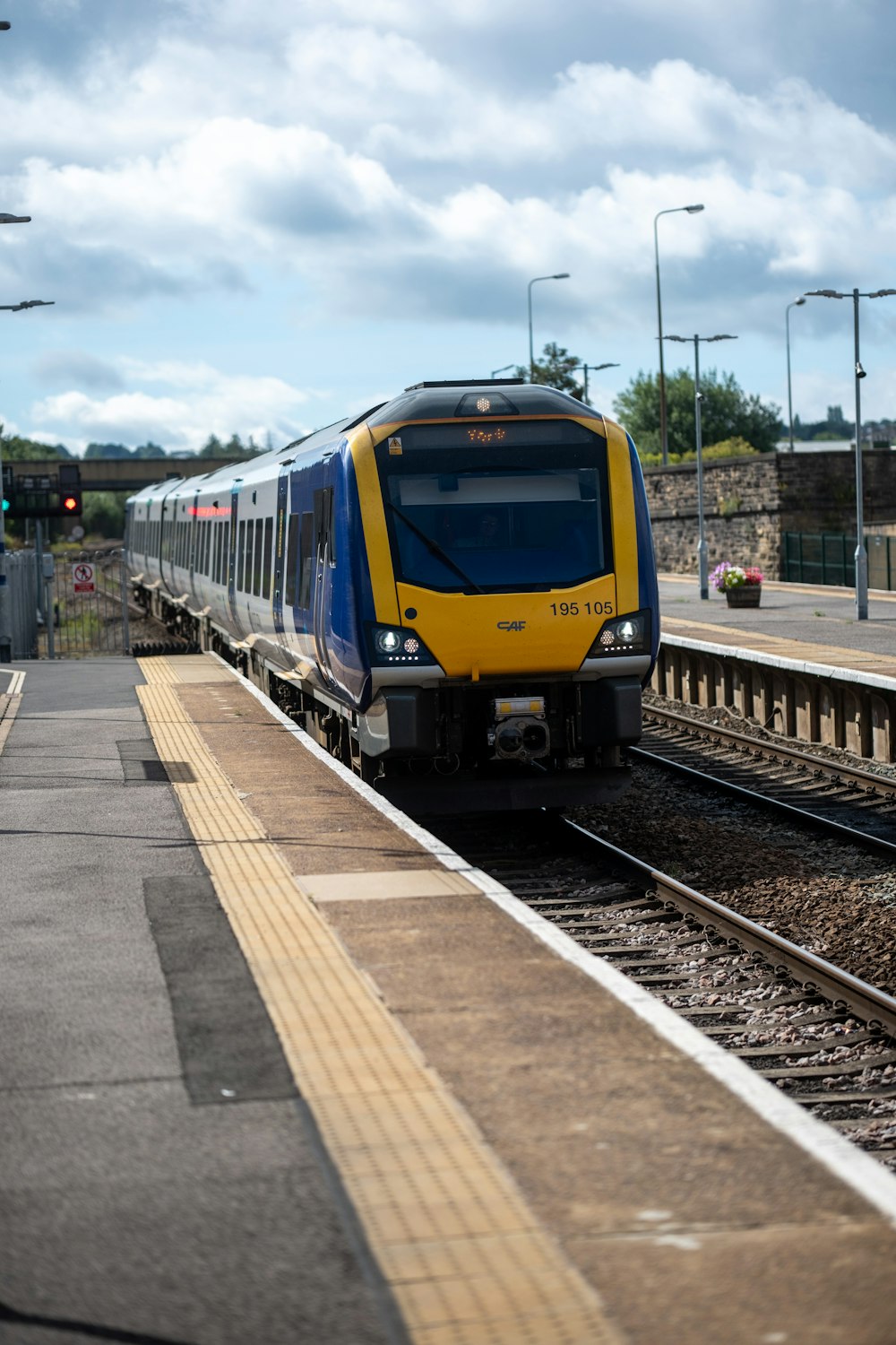 a yellow and blue train traveling down train tracks