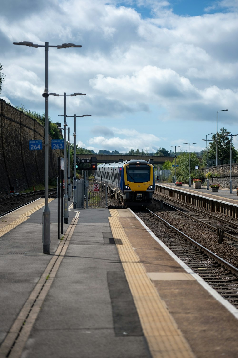 a yellow and blue train traveling down train tracks