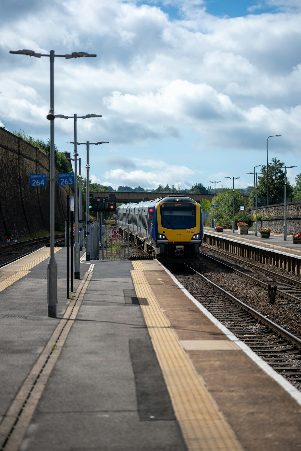 a yellow and blue train traveling down train tracks