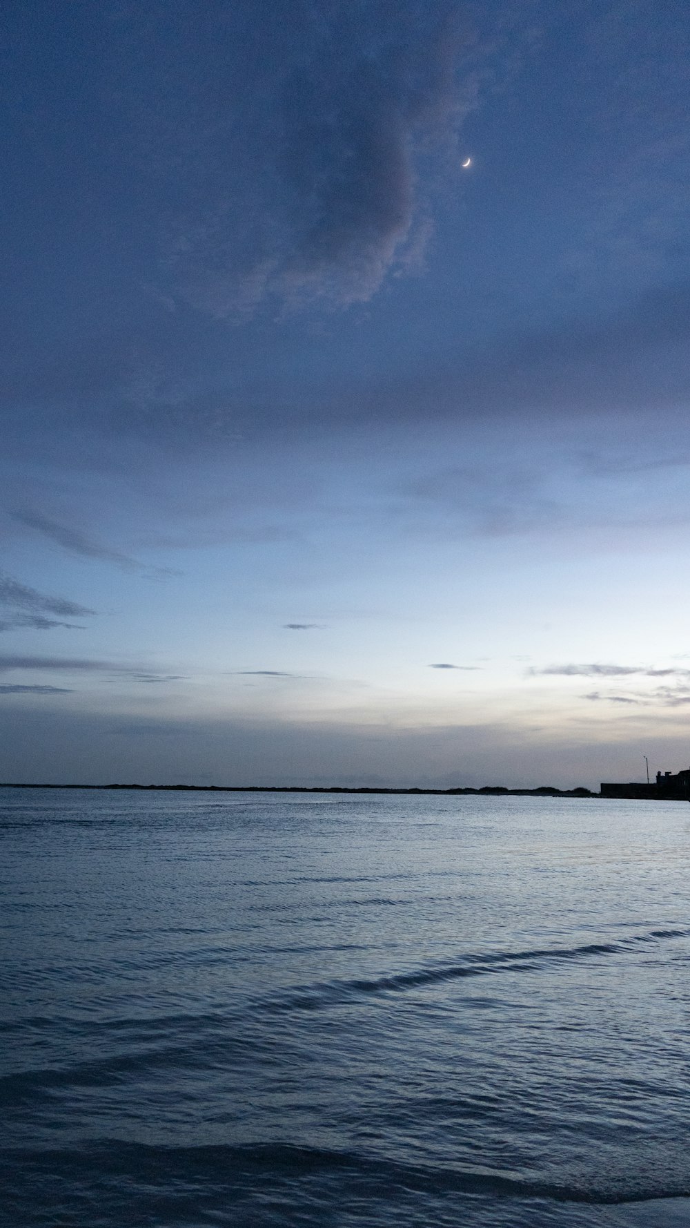 a body of water with a boat in the distance