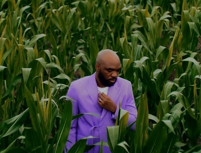 a man standing in a field of corn