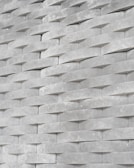 Close-up of a modern faux tile panel with a subtle texture on a clean white background