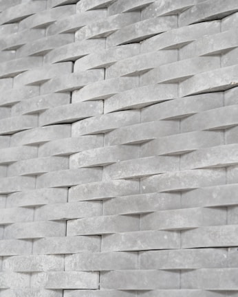 Close-up of a modern faux tile panel with a subtle texture on a clean white background
