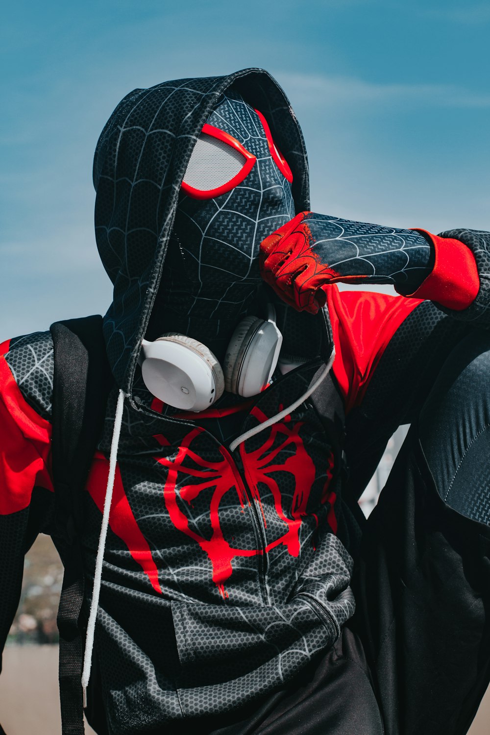 a person in a spider suit with headphones on