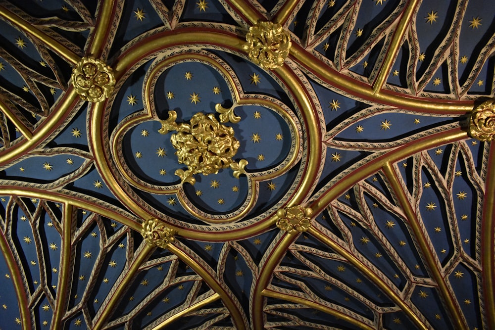 a close up view of a gold and blue ceiling