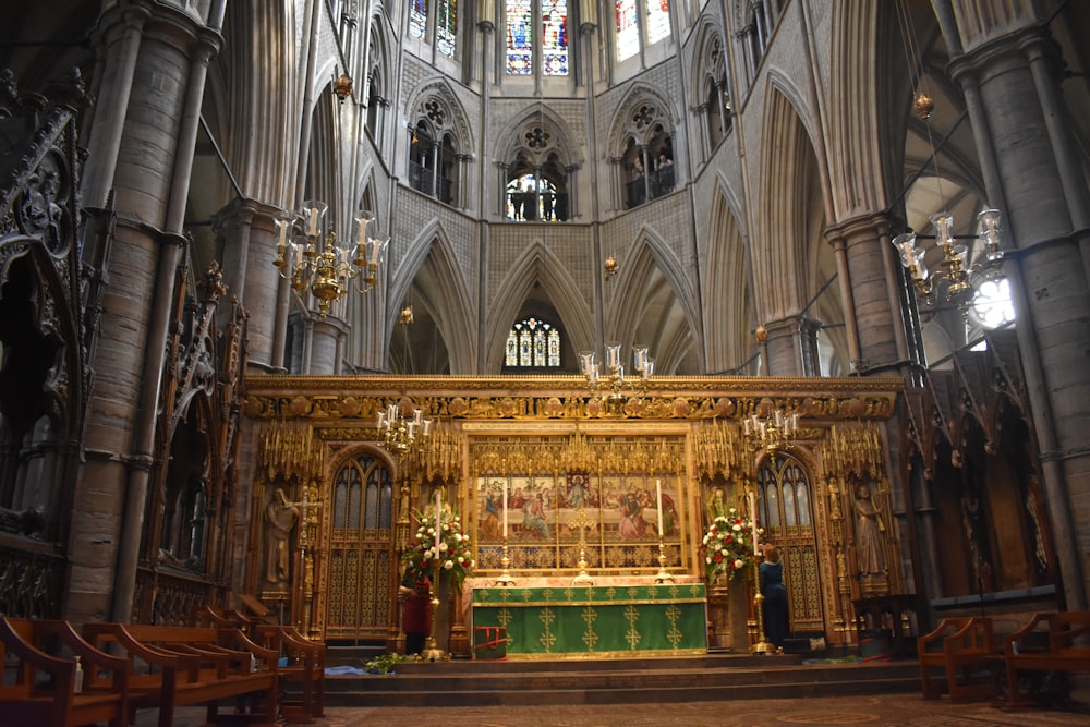 a large cathedral with a wooden alter and stained glass windows