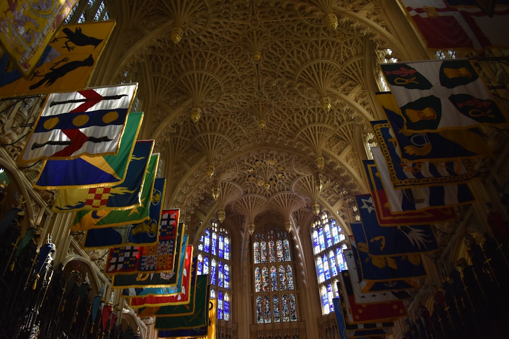 a large cathedral with many flags hanging from the ceiling
