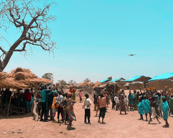 A synchronized drone swarm performing intricate patterns above a festive crowd.