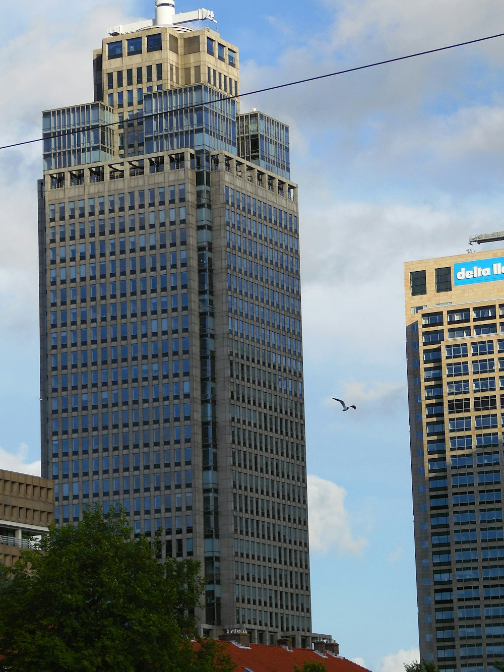 a tall building with a sign on the top of it