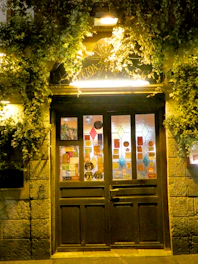 A welcoming doorway with a sign pointing to bloomnart.org.
