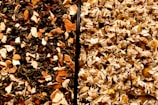 A close-up view of two different mixtures, separated by a vertical line. On the left, a blend of assorted dried leaves and orange peel in dark and light brown shades. On the right, dried chamomile flowers with pale yellow petals and light brown centers.