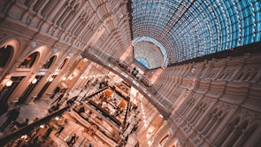 Interior view of a vibrant commercial space with people shopping and socializing.
