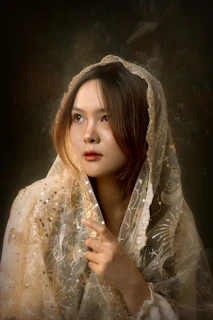 Close-up of a richly embroidered maroon shawl showcasing delicate gold threadwork.