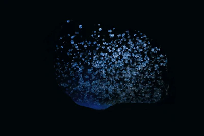 An abstract visual of interconnected story nodes glowing softly against a deep black space backdrop.