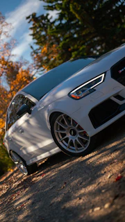 A premium white car gleaming under the Varna sun, highlighting its polished finish