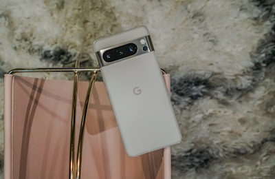 Google Pixel phone resting on a soft pink surface with white accents.