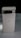 A sleek, modern smartphone with a metallic and glass finish, prominently featuring a camera array on the upper back and the Google logo in the center. The phone is positioned upright against a dark background, highlighting its elegant design.