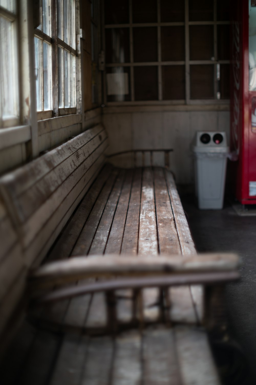 a wooden bench sitting next to a red door
