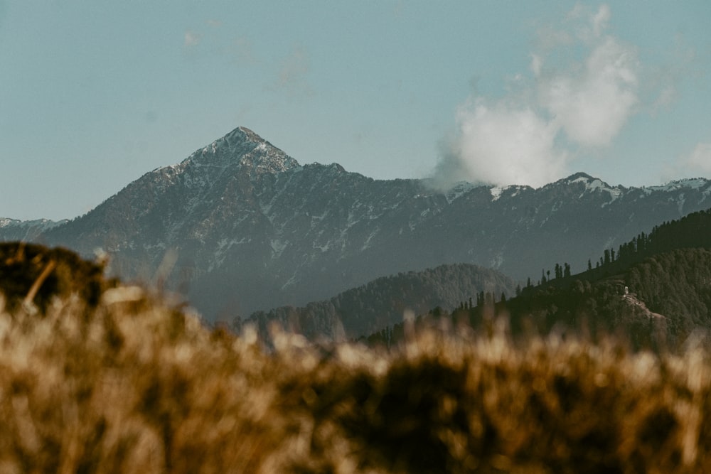 a view of a mountain range with clouds in the sky