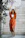 A smiling woman standing barefoot on a velora anti-slip bathroom mat in a bright bathroom.