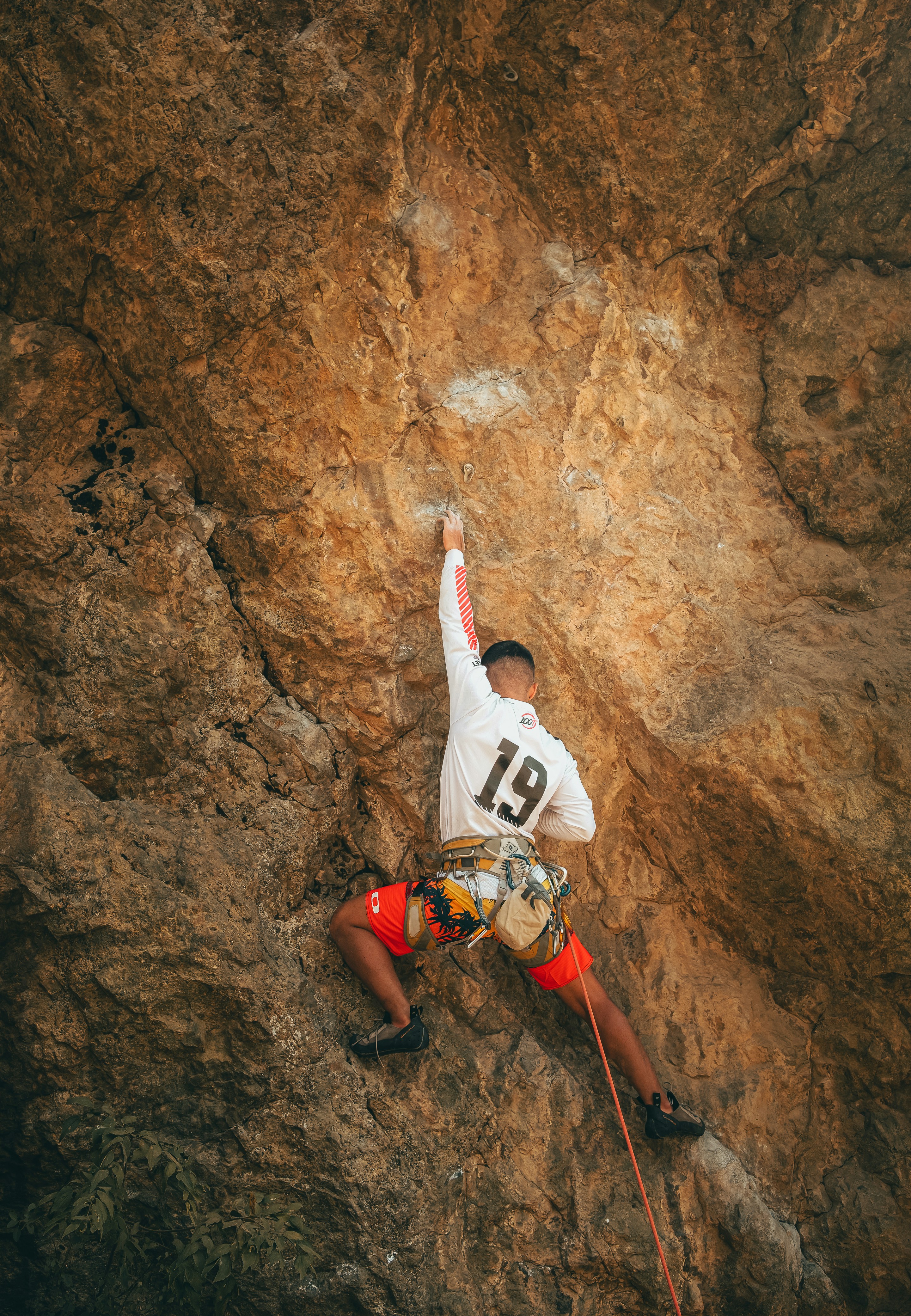 a man climbing up the side of a mountain