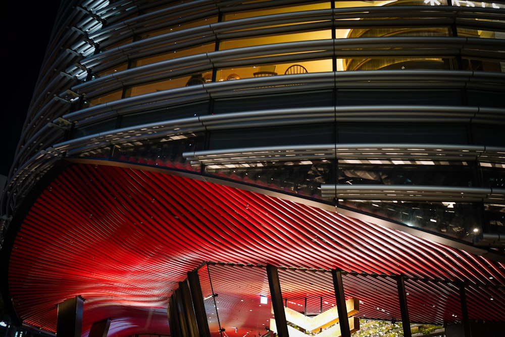 a large building with a red curved roof