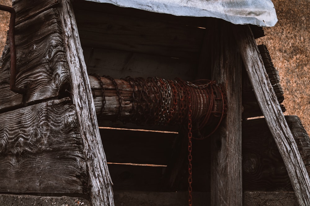 a close up of a wooden structure with chains hanging from it