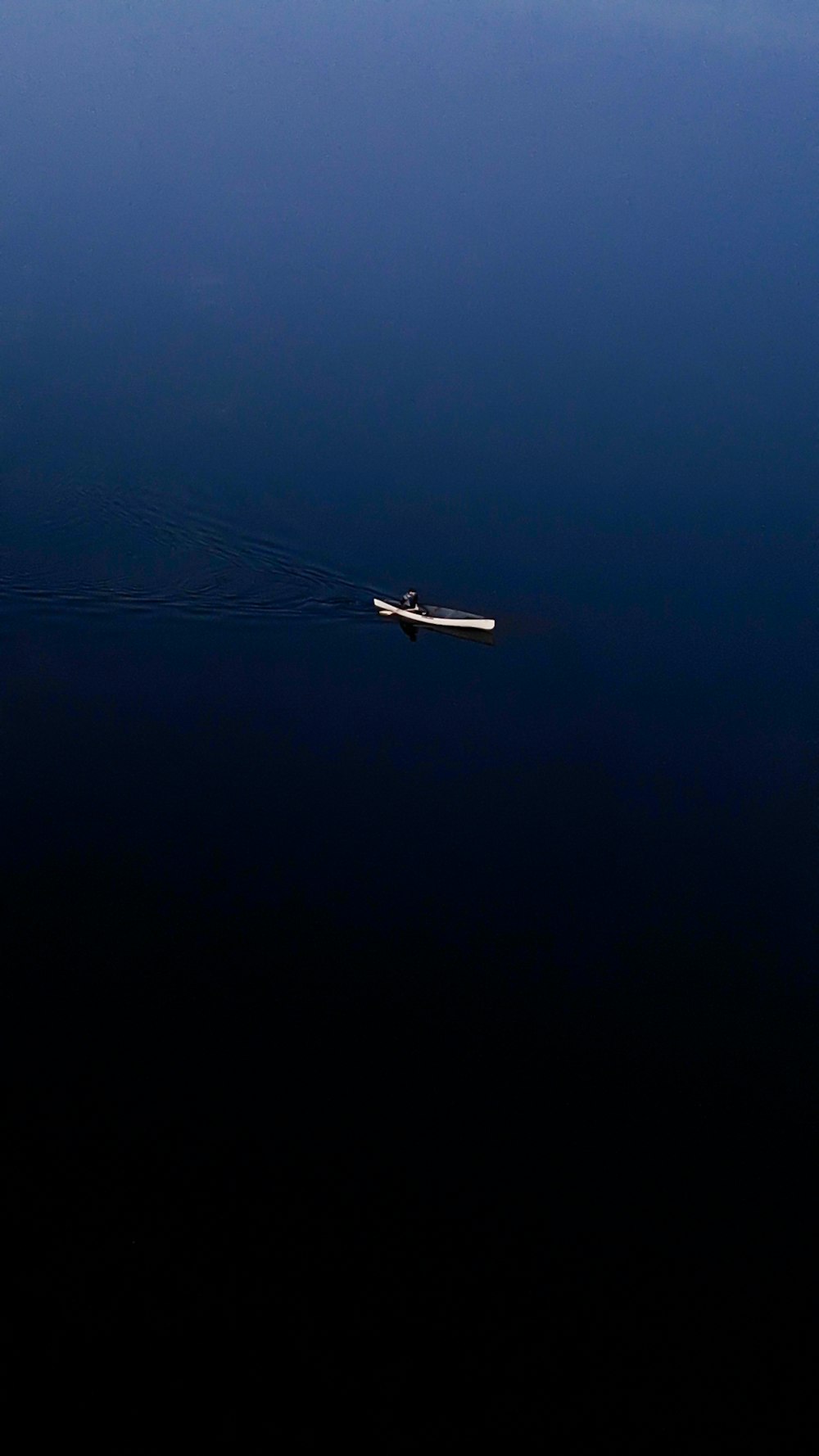 a boat floating in the middle of a body of water