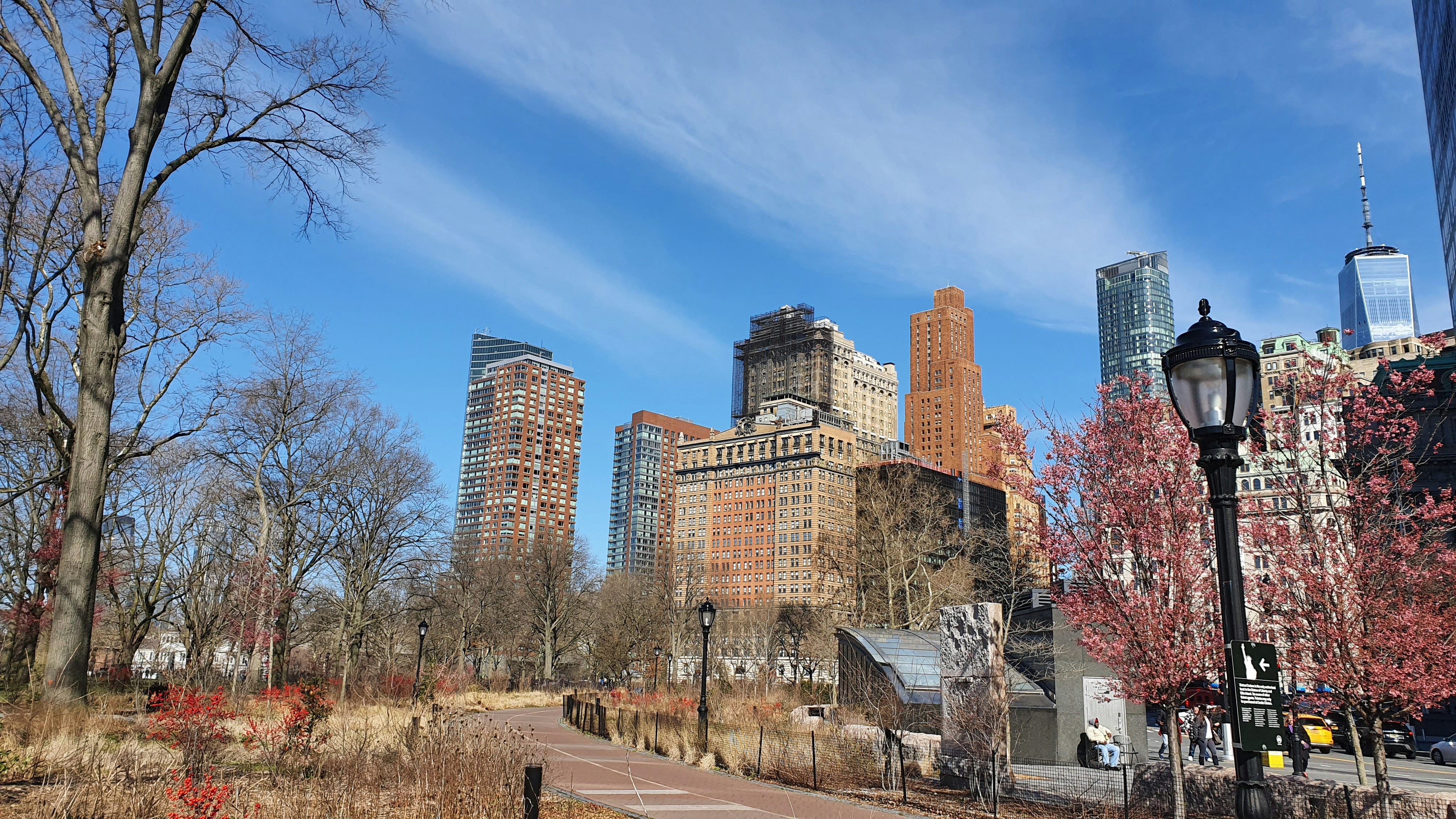 a city street with tall buildings in the background