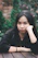 a woman sitting at a table with her hand on her face