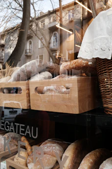 A cozy bakery storefront with fresh bread displayed in the window on a sunny morning.
