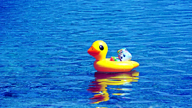 Bright illustration of a cheerful yellow duck wearing a little backpack, ready for an adventure.
