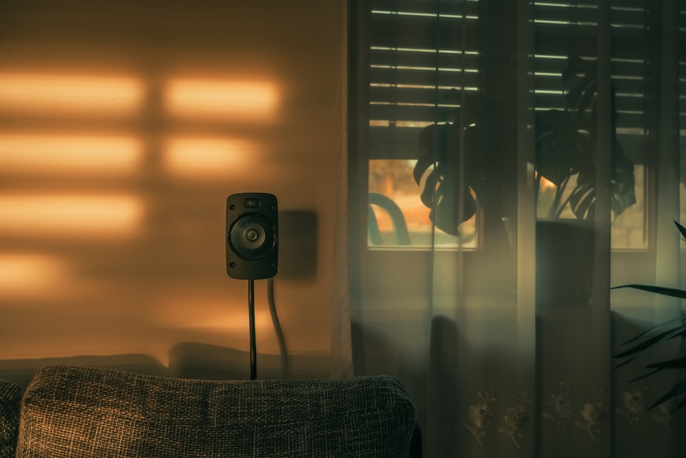 a living room with a couch and a speaker